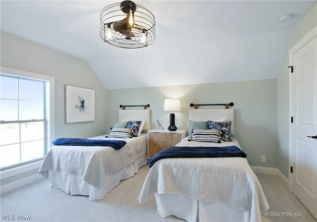 bedroom featuring lofted ceiling, multiple windows, and carpet floors