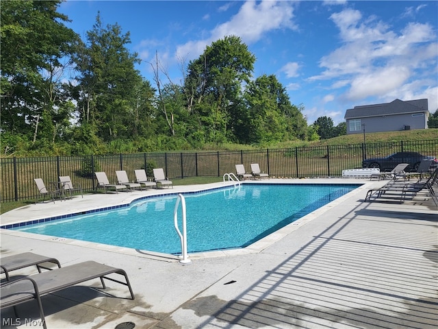 view of swimming pool featuring a patio area