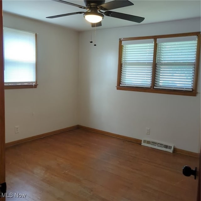 unfurnished room with hardwood / wood-style flooring and ceiling fan