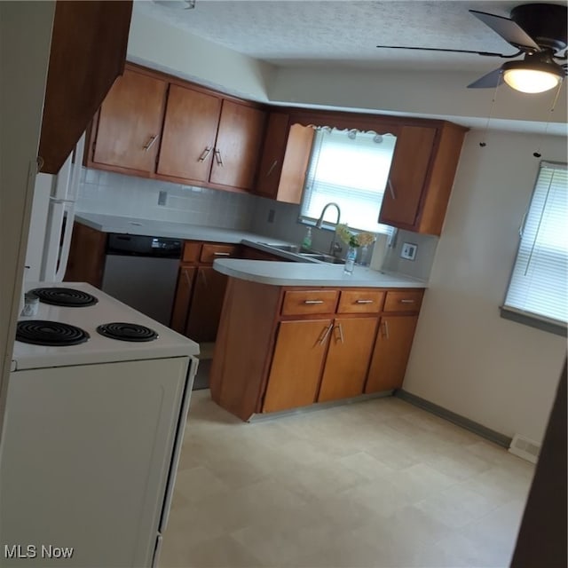 kitchen with plenty of natural light, ceiling fan, white appliances, and tasteful backsplash