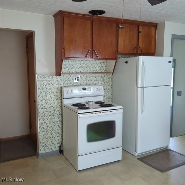 kitchen featuring light tile patterned floors and white appliances