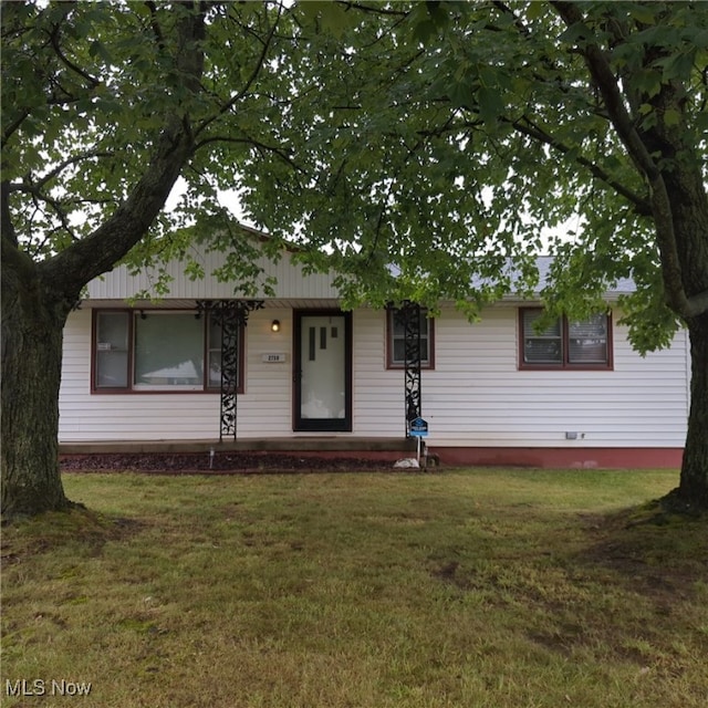 ranch-style home with a front lawn