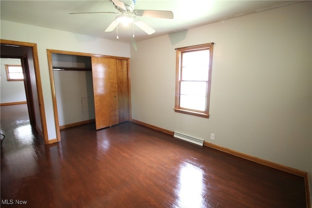 unfurnished bedroom featuring hardwood / wood-style flooring, a closet, and multiple windows