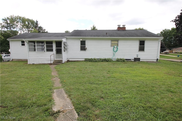 back of house featuring a yard