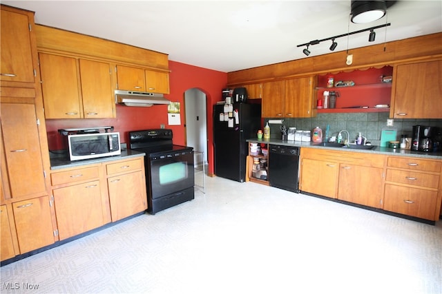 kitchen featuring sink, decorative backsplash, rail lighting, and black appliances