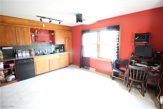 kitchen with dishwasher, decorative backsplash, sink, track lighting, and ceiling fan