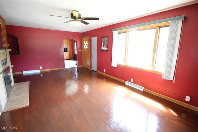 unfurnished living room with ceiling fan, wood-type flooring, and a fireplace