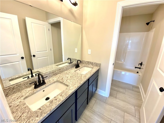 bathroom with vanity and washtub / shower combination