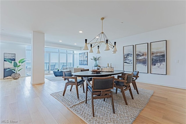 dining room featuring a chandelier and light hardwood / wood-style flooring