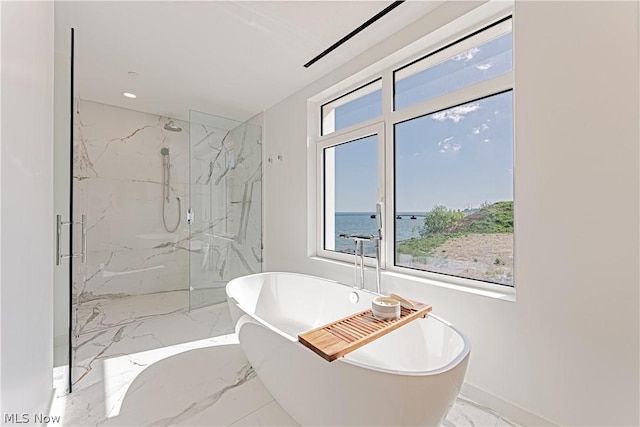 bathroom with a water view and independent shower and bath