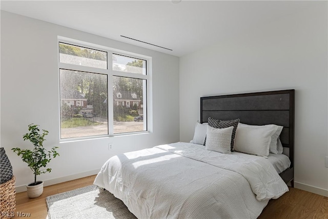 bedroom with hardwood / wood-style flooring