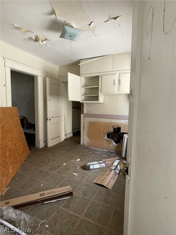 kitchen featuring dark tile flooring