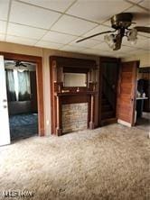 unfurnished living room featuring a ceiling fan and a paneled ceiling