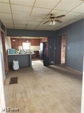 kitchen with a drop ceiling, baseboards, and ceiling fan