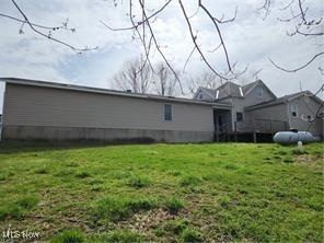 back of house with a lawn