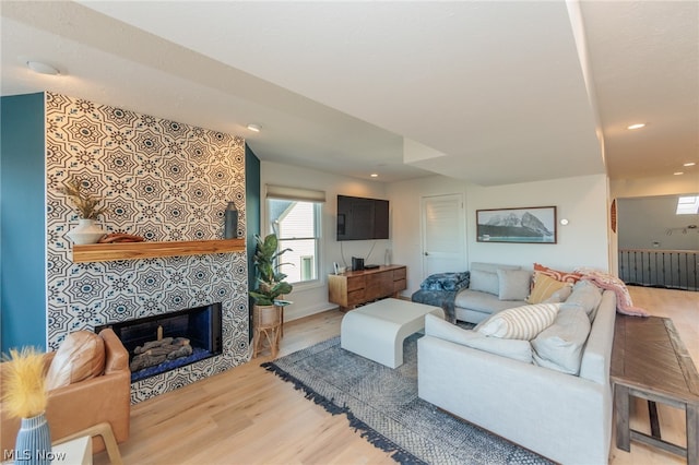 living room featuring hardwood / wood-style floors and a tiled fireplace