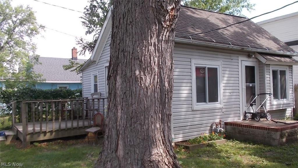 view of home's exterior with a wooden deck
