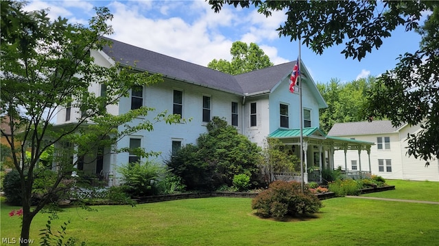 back of property featuring a lawn