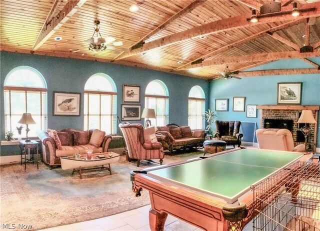 recreation room with ceiling fan, a fireplace, light tile floors, and billiards