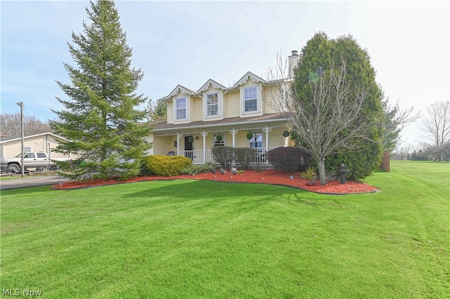 view of front of property with a porch and a front lawn