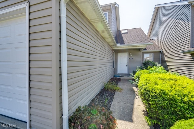 view of exterior entry with a garage