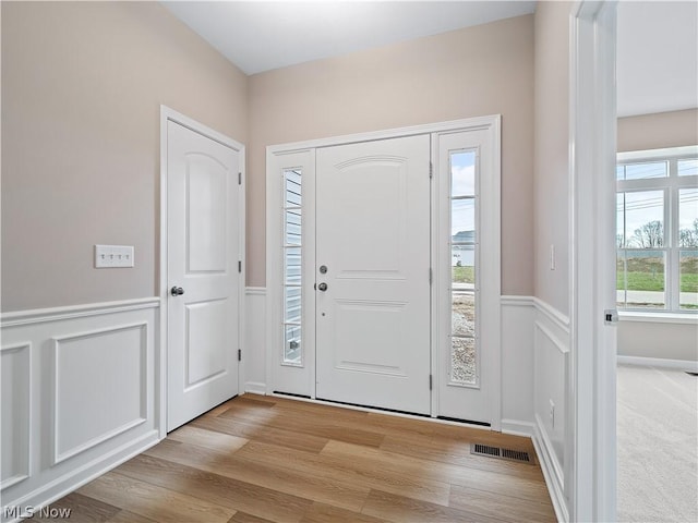 entrance foyer with a healthy amount of sunlight and light hardwood / wood-style flooring