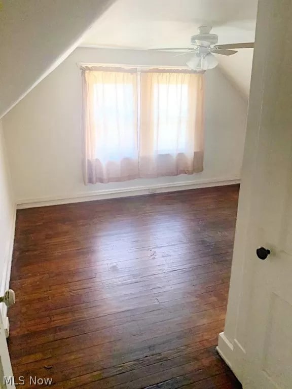 bonus room with dark wood-type flooring, ceiling fan, and vaulted ceiling