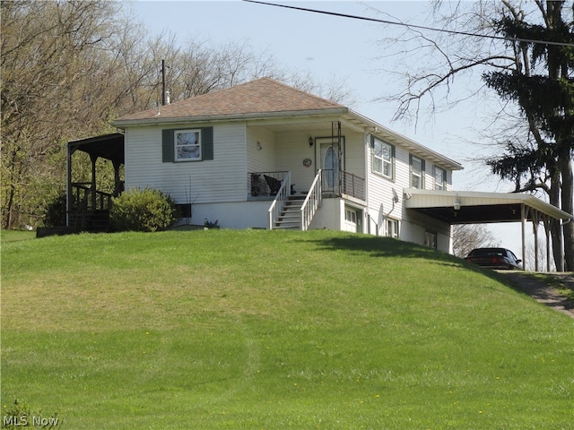 view of front facade featuring a front lawn and a carport