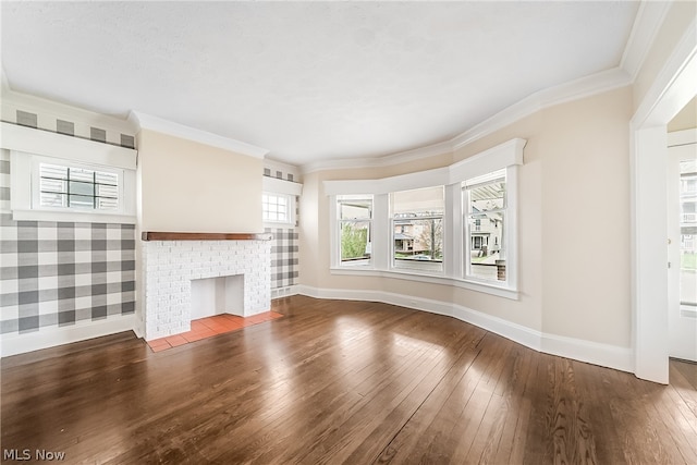 unfurnished living room featuring dark hardwood / wood-style floors, ornamental molding, and a brick fireplace