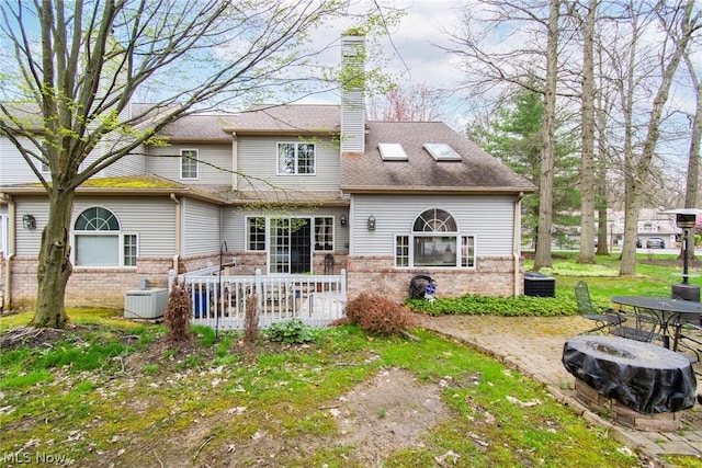 6747 Lockwood Blvd, Youngstown, OH 44512 - back of house featuring brick siding, cooling unit, a chimney, and a patio