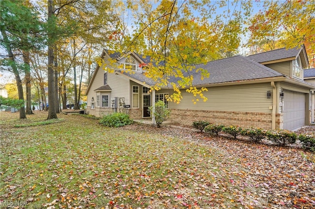 view of front of home with a front lawn and a garage