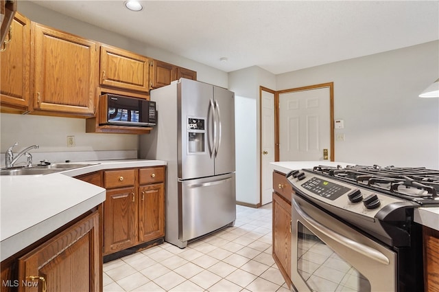 kitchen with sink, light tile patterned floors, and stainless steel appliances