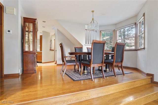 6747 Lockwood Blvd, Youngstown, OH 44512 - dining area featuring a chandelier, light wood-type flooring, and baseboards