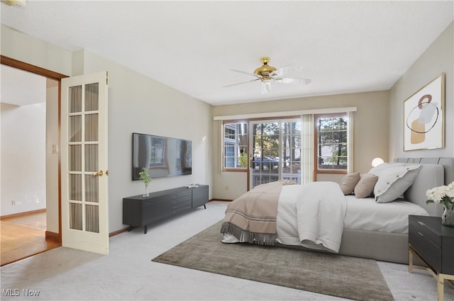 bedroom featuring access to outside, light carpet, and ceiling fan