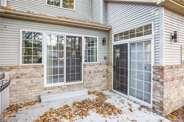 view of exterior entry with a wooden deck