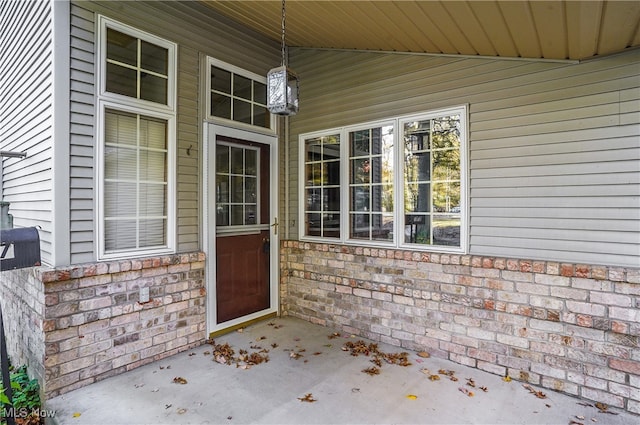 view of exterior entry with covered porch