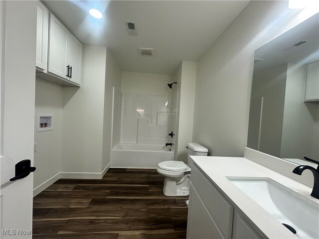 full bathroom featuring vanity, toilet, shower / washtub combination, and hardwood / wood-style floors