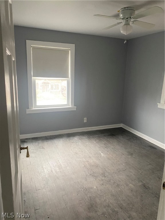 empty room with wood-type flooring and ceiling fan