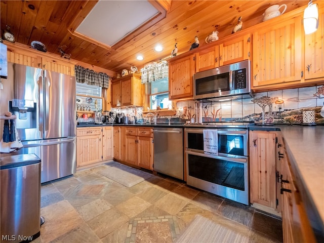 kitchen featuring wooden ceiling, appliances with stainless steel finishes, tile flooring, sink, and tasteful backsplash