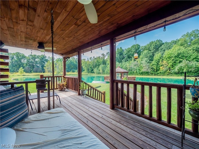 wooden terrace featuring a yard