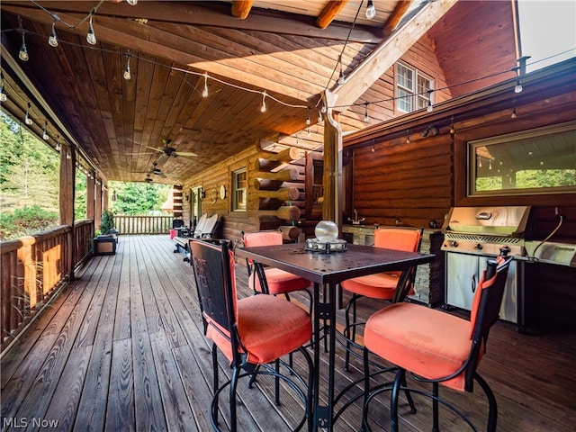 wooden deck featuring area for grilling and ceiling fan