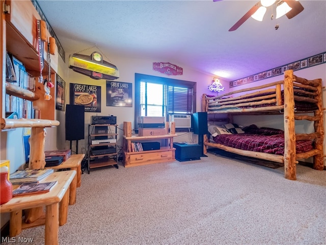 bedroom featuring ceiling fan, carpet flooring, and a textured ceiling