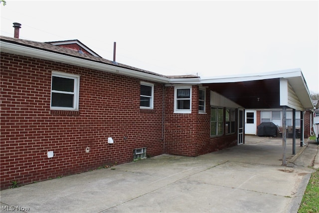 view of home's exterior featuring a carport