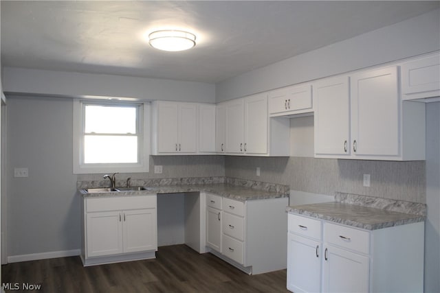 kitchen featuring sink, white cabinetry, and dark hardwood / wood-style flooring