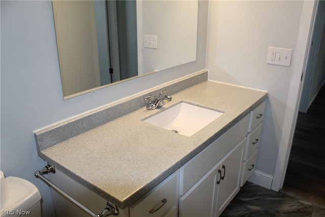 bathroom with vanity, tile patterned flooring, and toilet