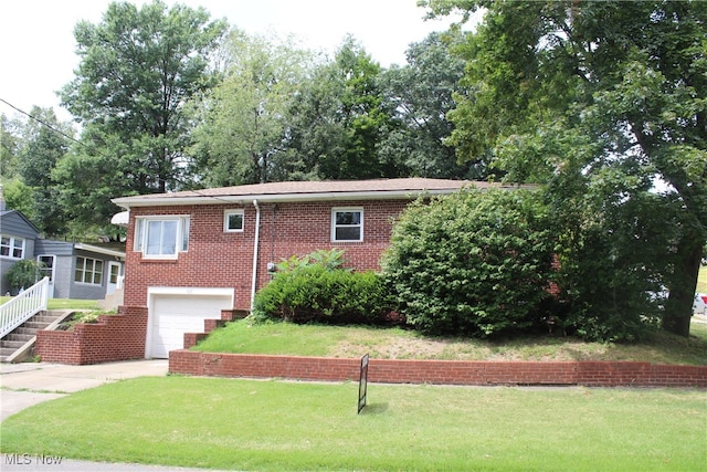 view of front of home with a garage and a front yard