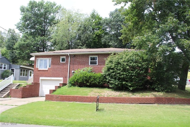 view of front of property with a garage and a front lawn