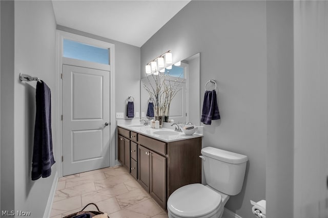 bathroom featuring tile floors, toilet, and dual bowl vanity