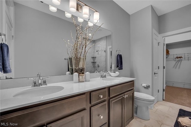 bathroom with tile floors, toilet, double sink, and large vanity