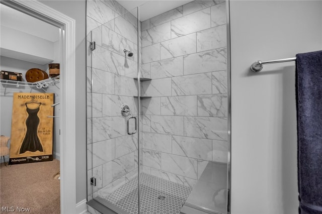 bathroom with a shower with shower door